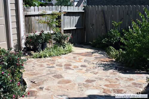 Beautiful stone patio design with lush garden landscaping by John Russell Landscape Architect. Perfect for outdoor living and garden enhancement.