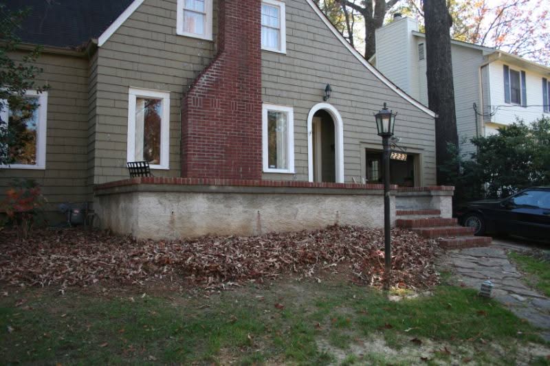Gorgeous landscaped front yard with brick staircase, vintage street lamp, and mature trees; professional residential landscape design by John Russell Landscape Architect enhancing curb appeal.