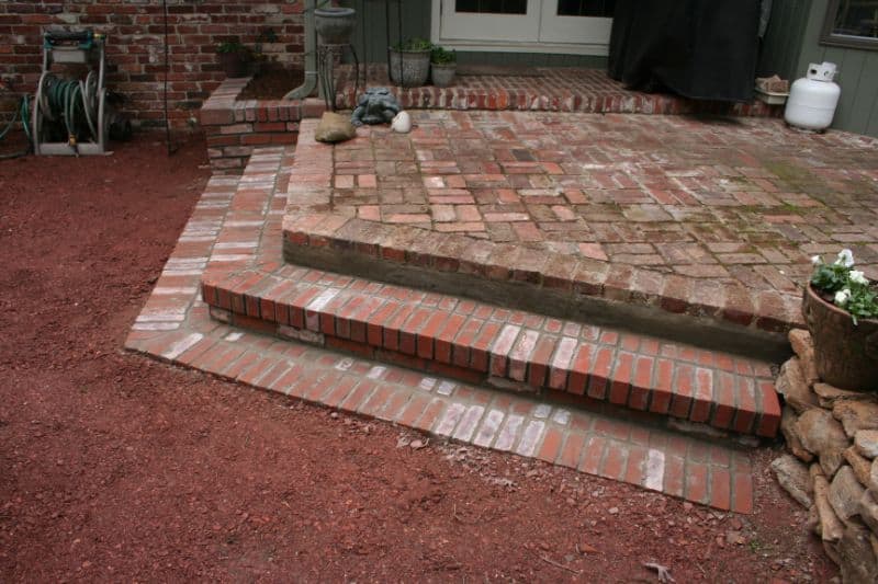 Brick patio step construction by John Russell Landscape Architect for elegant outdoor living spaces.