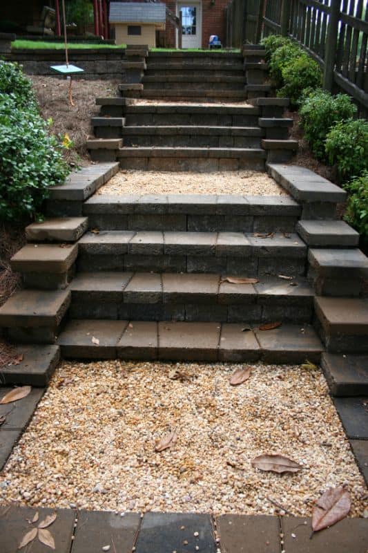 Elegant outdoor staircase with layered stone steps for a landscaped garden design by John Russell Landscape Architect. Perfect for enhancing curb appeal and functional outdoor living spaces.