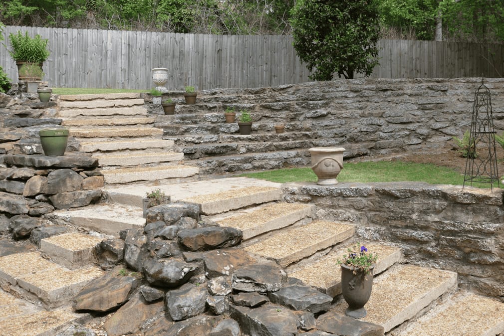 Natural stone landscape steps with potted plants under professional landscape design by John Russell Landscape Architect.