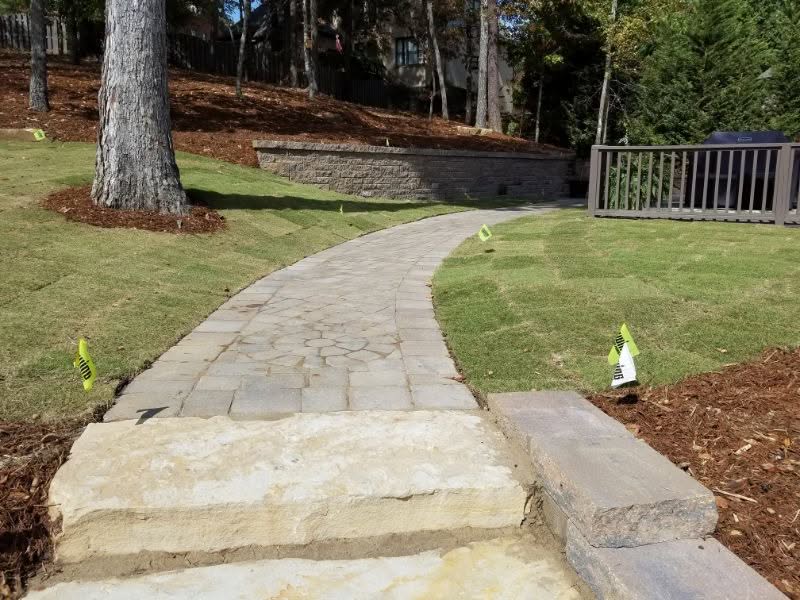 Curved stone pathway design by John Russell Landscape Architect, enhancing garden aesthetics and functionality. Expertly crafted for elegant outdoor landscaping projects.