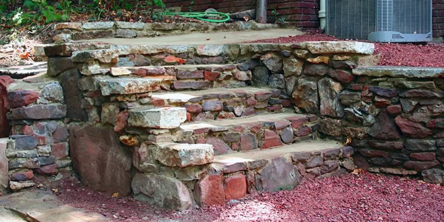 Natural stone staircase design for outdoor landscape renovation by John Russell Landscape Architect. Expert in creating durable, aesthetically pleasing landscape architecture solutions.
