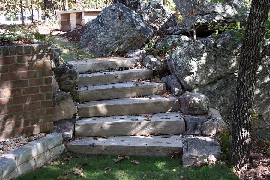 Natural stone outdoor staircase with rugged rocks and lush landscaping, showcasing professional landscape architecture by John Russell Landscape Architect.