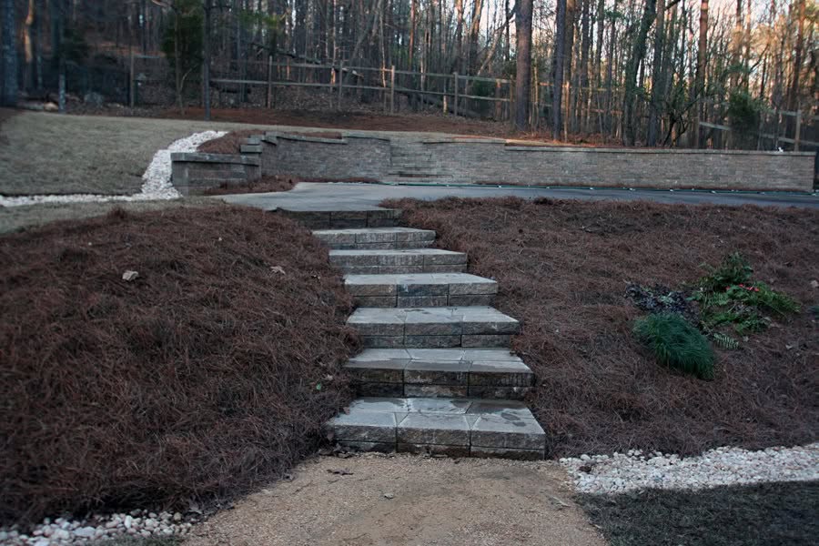 Staircase landscape design with stone steps and mulched garden beds, showcasing expert outdoor landscaping by John Russell Landscape Architect.