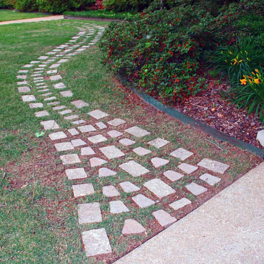 Flagstone garden pathway, landscaping design idea, professional landscape architect services, John Russell Landscape Architect, beautiful outdoor walkway design with natural stone accents, garden pathway with curved design, expert landscape planning and implementation.