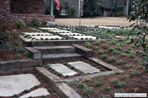 Natural stone pathway with modern landscape design by John Russell Landscape Architect, featuring innovative hardscaping and lush planting for elegant outdoor spaces.