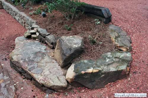 Large rock landscaping feature in a garden design by John Russell Landscape Architect.