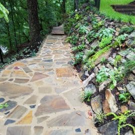 Natural stone walkway with lush greenery and landscaped garden landscaping by John Russell Landscape Architect.